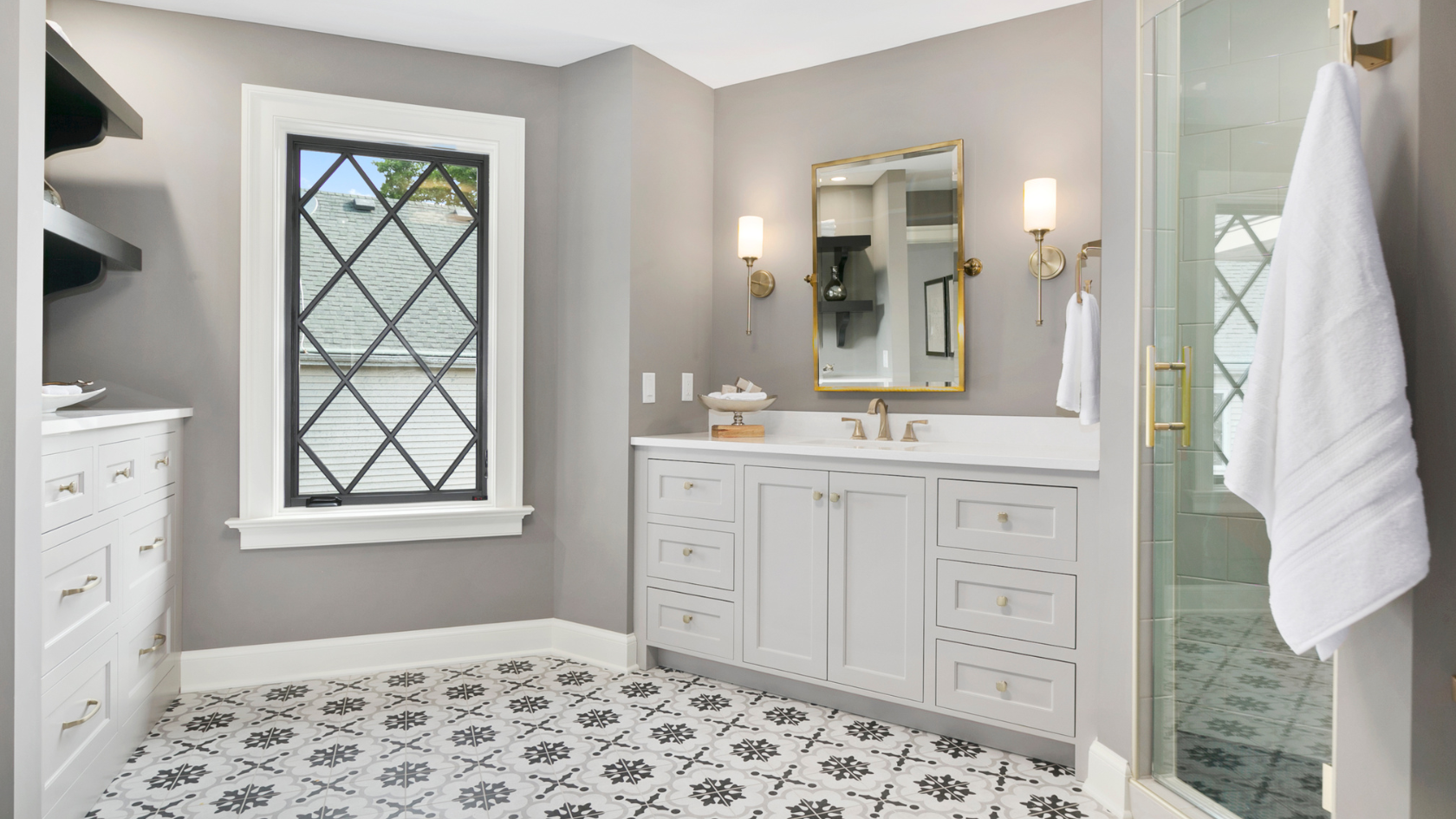 A bathroom with a sink, mirror, and shower