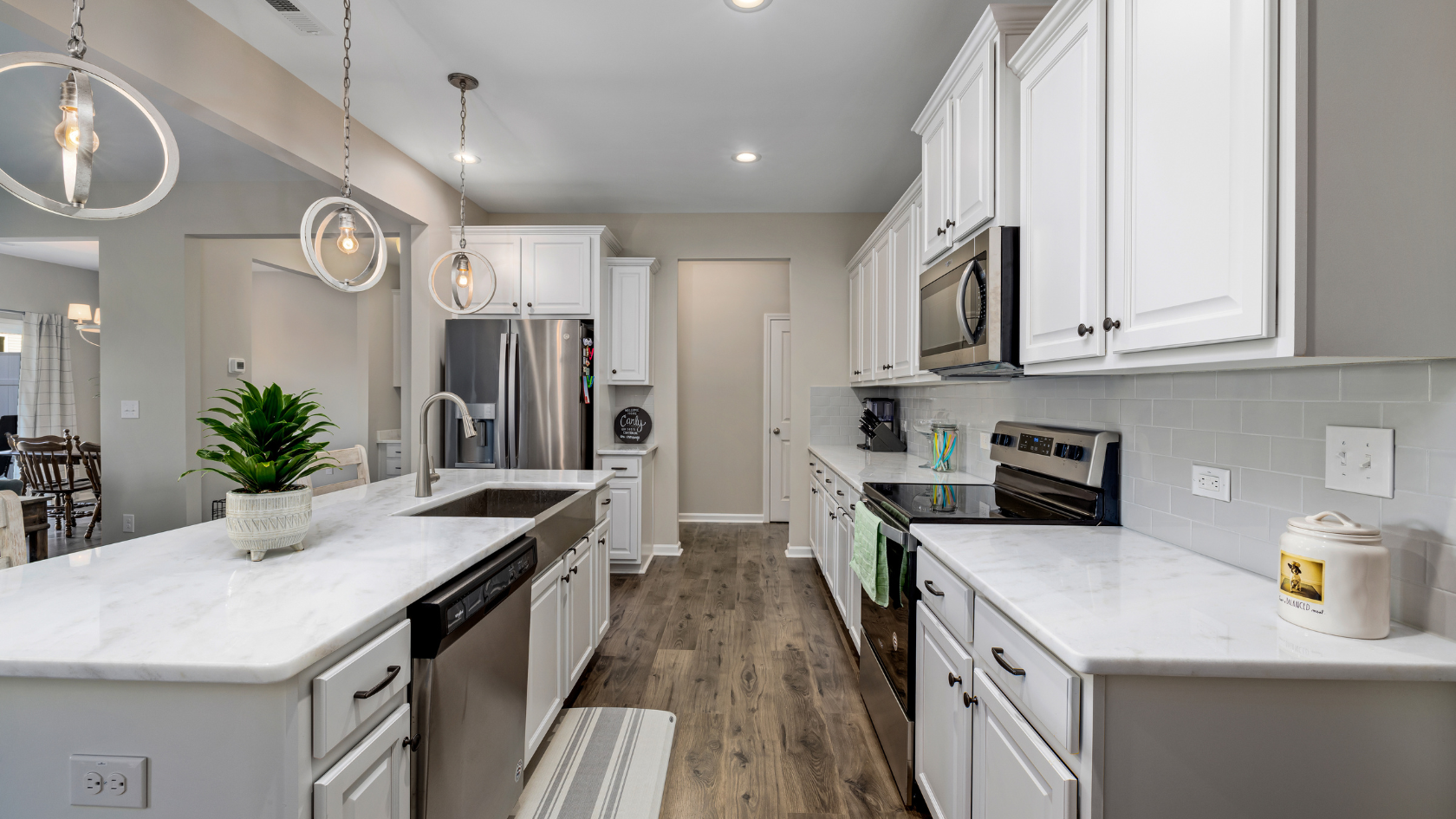 A kitchen with white cabinets and a center island