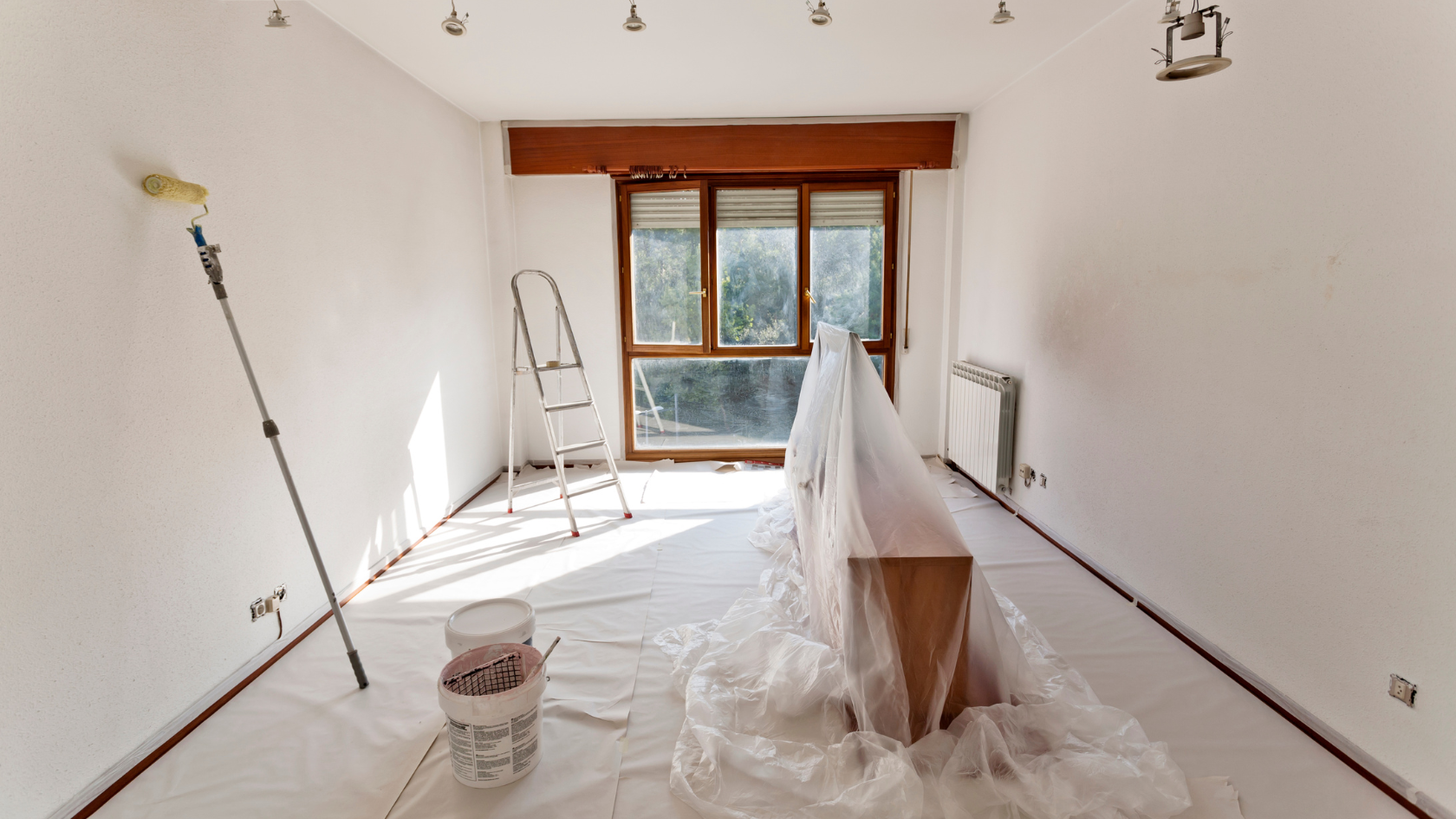 A room that has been painted white with a lot of paint